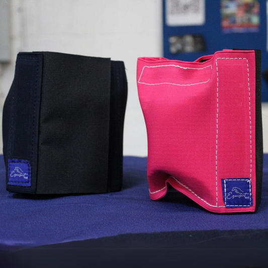 Kids Equiseat Aids in French Navy and Cerise Pink sat on a blue table