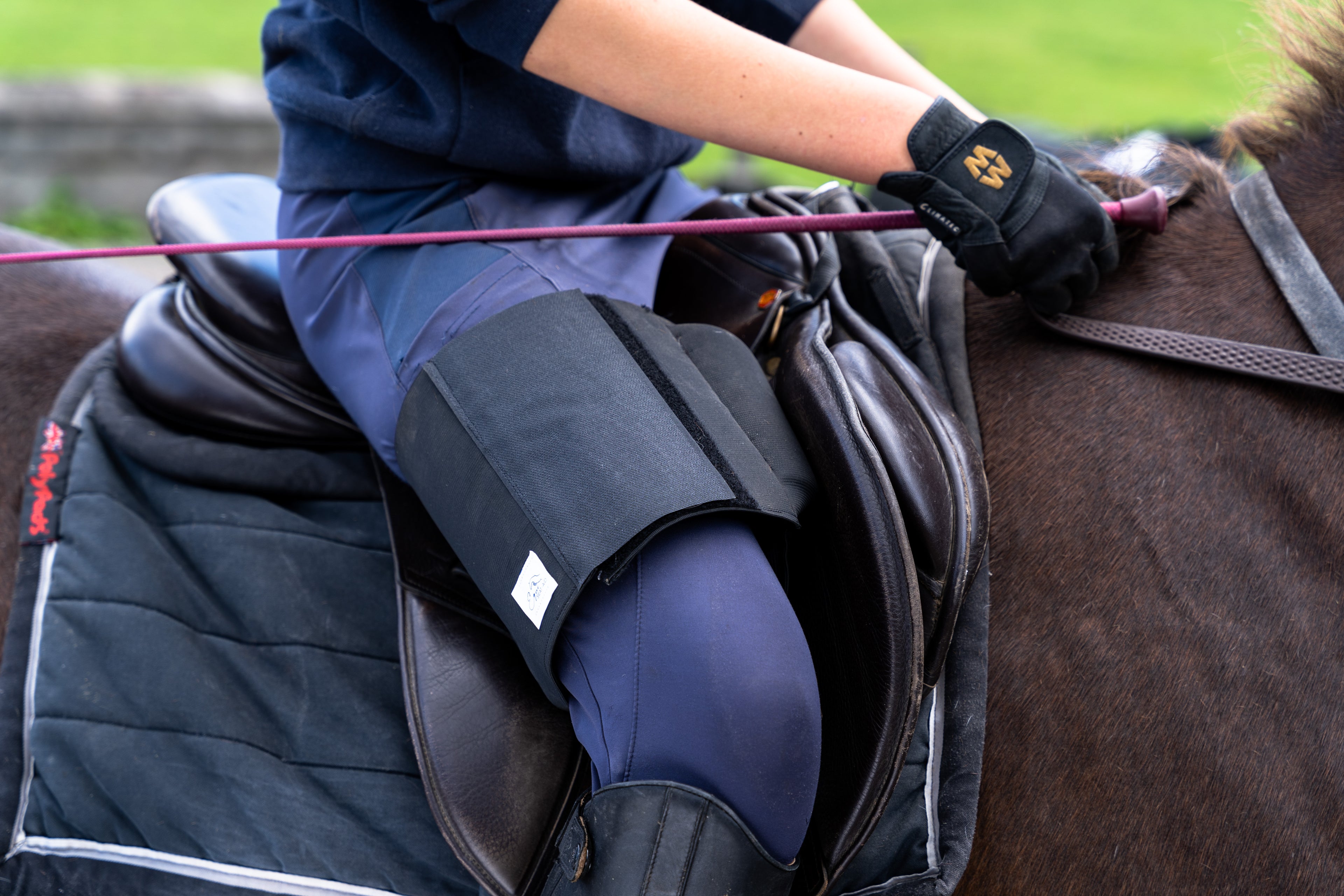 Horse rider wearing a black Equiseat Aid