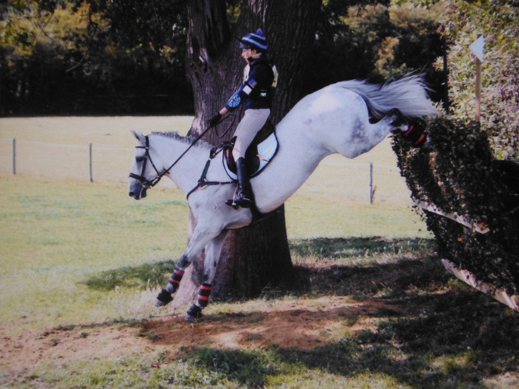 Ella Gay jumping a grey horse cross country