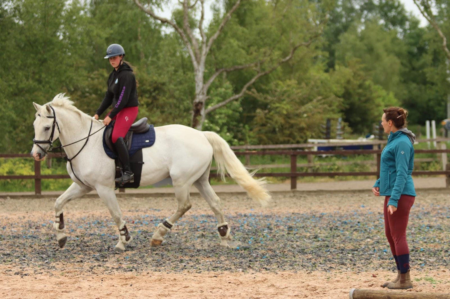 Image of Leanne Heslop training girl on grey horse