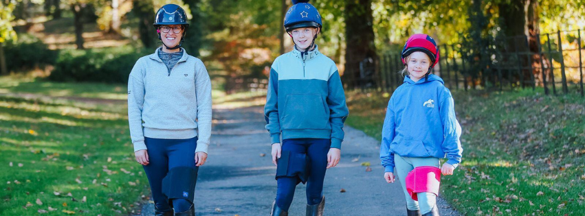 3 Horse riders all wearing their Equiseat Aid, featuring the black, French navy and cerise pink aid. 